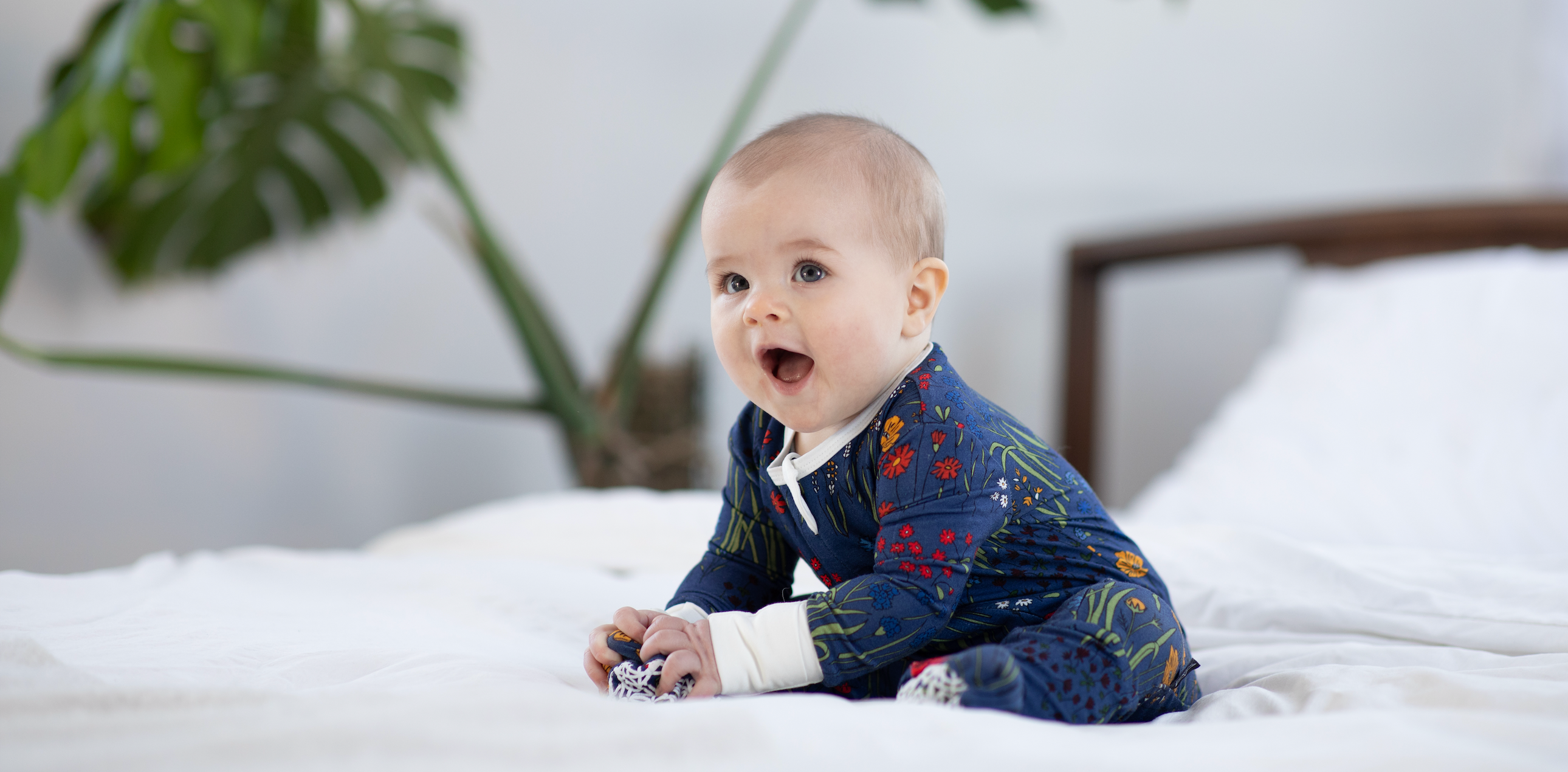 a baby wearing bamboo footie pajamas in floral print